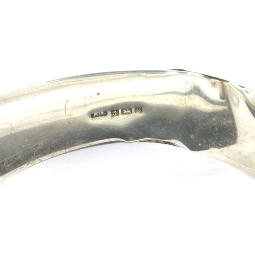 73 - Hallmarked silver snap bangle with safety chain, D: 65 mm, 23g, slight dent to silver. P&P Group 1 (... 
