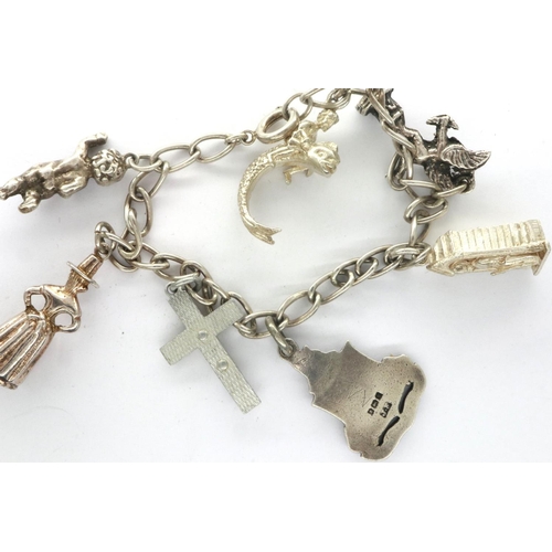 93 - 925 silver charm bracelet, with seven charms, L: 18 cm. P&P Group 1 (£14+VAT for the first lot and £... 