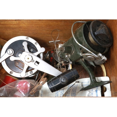 187 - A box of fishing reels and further fishing accessories including weights. P&P Group 2 (£18+VAT for t... 