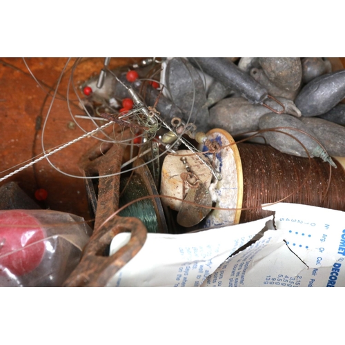 187 - A box of fishing reels and further fishing accessories including weights. P&P Group 2 (£18+VAT for t... 