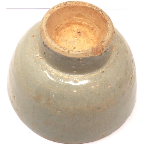 297 - A Ming Dynasty celadon glazed bowl, footed, D: 13 cm, H: 80 mm, losses to rim. P&P Group 1 (£14+VAT ... 