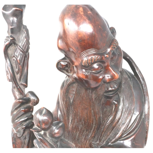303 - Carved hardwood statue of Shou Lao (Shou Xing) Taoist God of Longevity, standing on a bat, H: 60 cm.... 