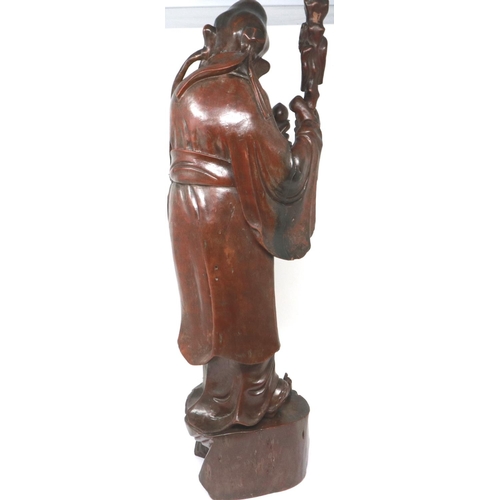303 - Carved hardwood statue of Shou Lao (Shou Xing) Taoist God of Longevity, standing on a bat, H: 60 cm.... 