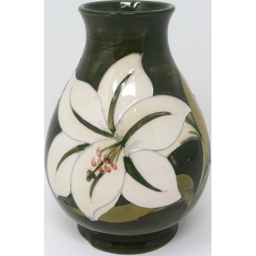 222 - Green ground Moorcroft vase in the Hibiscus pattern, with The Late Queen Mary sticker to base (distr... 
