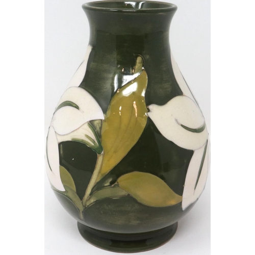 222 - Green ground Moorcroft vase in the Hibiscus pattern, with The Late Queen Mary sticker to base (distr... 
