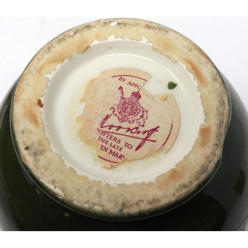 222 - Green ground Moorcroft vase in the Hibiscus pattern, with The Late Queen Mary sticker to base (distr... 