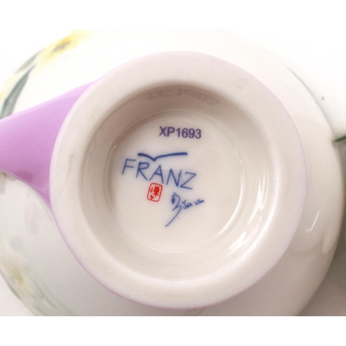 244 - Franz butterfly teacup with saucer and spoon. No visible chips or cracks. P&P Group 2 (£18+VAT for t... 