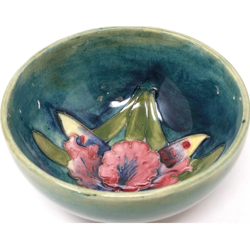 253 - Moorcroft footed bowl in the Iris pattern, D: 11 cm, small chip to rim and heavy crazing throughout,... 