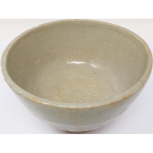 297 - A Ming Dynasty celadon glazed bowl, footed, D: 13 cm, H: 80 mm, losses to rim. P&P Group 1 (£14+VAT ... 