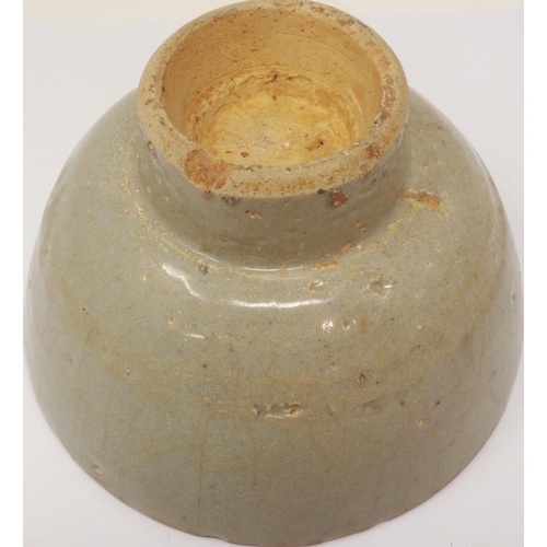 297 - A Ming Dynasty celadon glazed bowl, footed, D: 13 cm, H: 80 mm, losses to rim. P&P Group 1 (£14+VAT ... 
