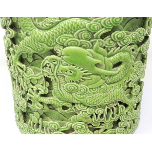 304 - Reticulated green ceramic Chinese brush pot with dragon decoration in relief, H: 18 cm, no cracks or... 