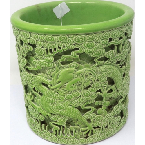 304 - Reticulated green ceramic Chinese brush pot with dragon decoration in relief, H: 18 cm, no cracks or... 