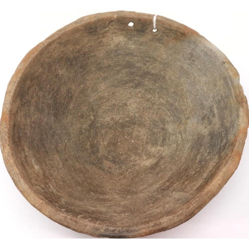 305 - A Han Dynasty grey clay bowl, with reticulated foot (likely for burner), D: 20 cm, H: 10 cm. Small l... 