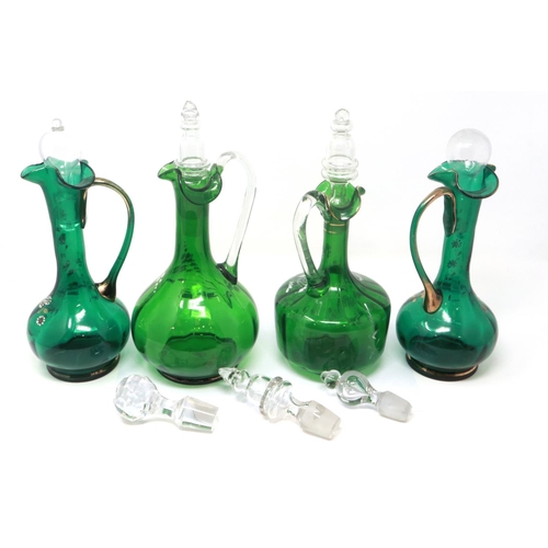 323 - Mary Gregory green glass decanter with enamelled cherub design and three similar examples with match... 