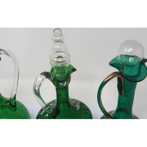 323 - Mary Gregory green glass decanter with enamelled cherub design and three similar examples with match... 