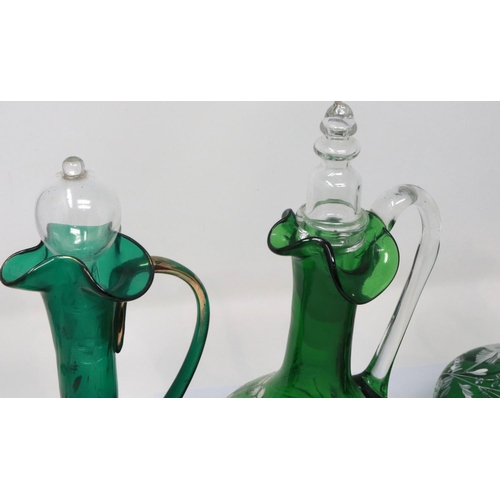 323 - Mary Gregory green glass decanter with enamelled cherub design and three similar examples with match... 