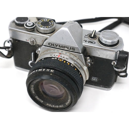 428 - Two Olympus OM-1 SLR cameras with lenses. P&P Group 1 (£14+VAT for the first lot and £1+VAT for subs... 