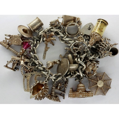 7 - Hallmarked silver charm bracelet with twenty seven charms, L: 18 cm, overall 89g. P&P Group 1 (£14+V... 