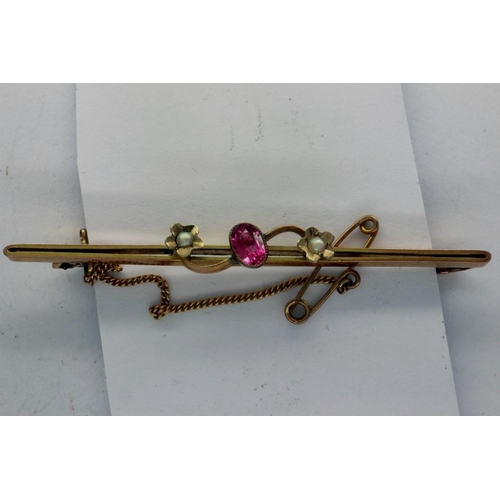 72 - 9ct gold bar brooch set with ruby and seed pearls with safety chain, L: 60 mm, 2.8g. P&P Group 1 (£1... 