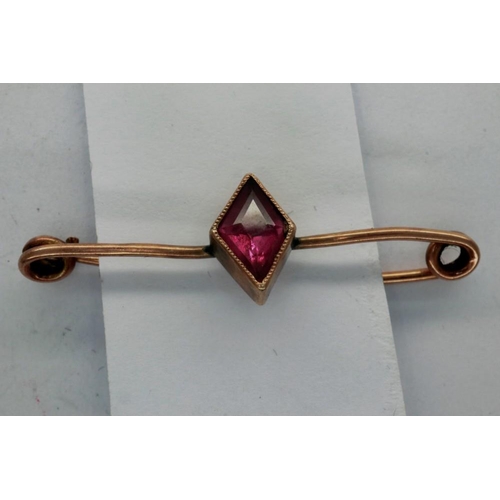 73 - Yellow metal bar brooch set with a single ruby. P&P Group 1 (£14+VAT for the first lot and £1+VAT fo... 