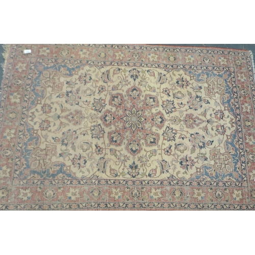 2095 - Early 20th century floor rug with designs in blue against a red faded ground, 155 x 100 cm. Not avai... 