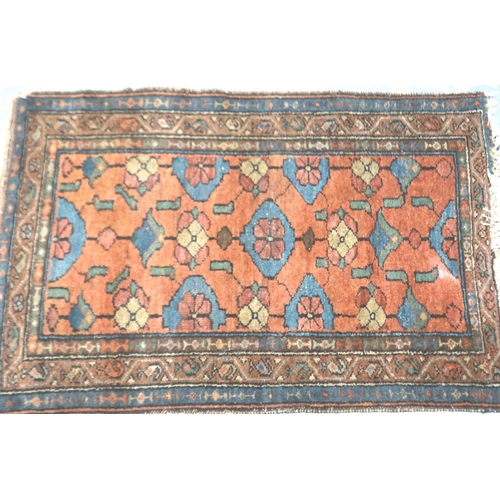 2096 - Late 19th century hand knotted floor rug with designs against an orange ground, 120 x 76 cm. Not ava... 