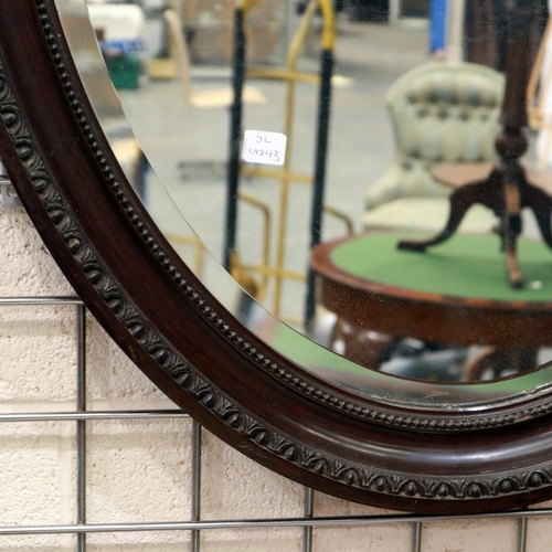 2087 - A large Victorian oval wall mirror with bevelled glass and carved mahogany frame, 100 x 70 cm. Not a... 