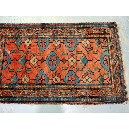 2096 - Late 19th century hand knotted floor rug with designs against an orange ground, 120 x 76 cm. Not ava... 