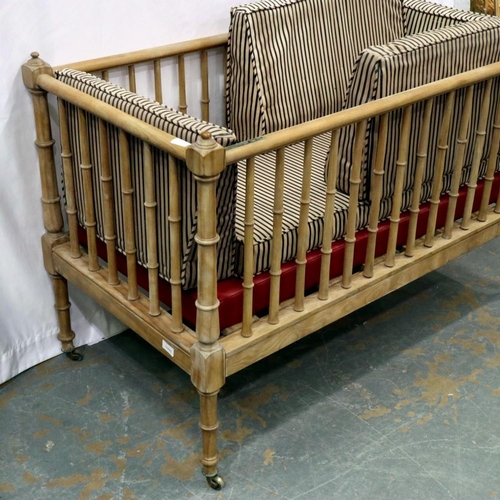 2115 - An Edwardian pine framed cot with one drop side and internal cushion, 127 x 63 x 81 cm H. Not availa... 