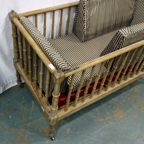 2115 - An Edwardian pine framed cot with one drop side and internal cushion, 127 x 63 x 81 cm H. Not availa... 