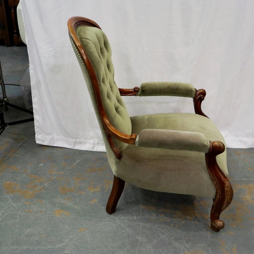 2123 - A Victorian walnut framed salon chair with buttoned back rest and scrolling arms. Not available for ... 