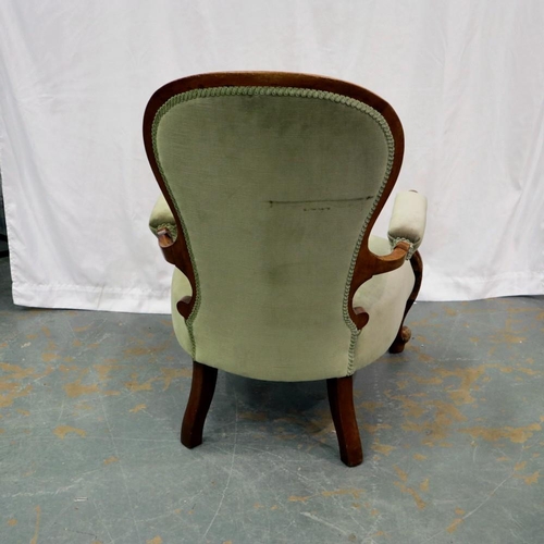 2123 - A Victorian walnut framed salon chair with buttoned back rest and scrolling arms. Not available for ... 