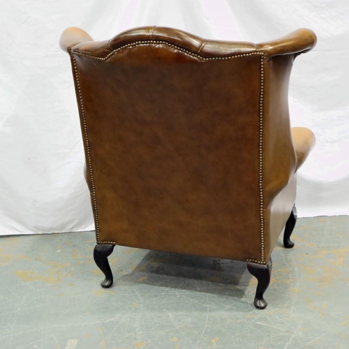 2140 - Brown leather button back winged armchair with extra seat cushion. Not available for in-house P&P