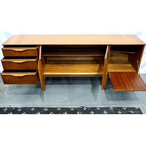 2161 - Long teak sideboard with central cupboard door, drop down asymmetric cupboard and three drawers, 183... 