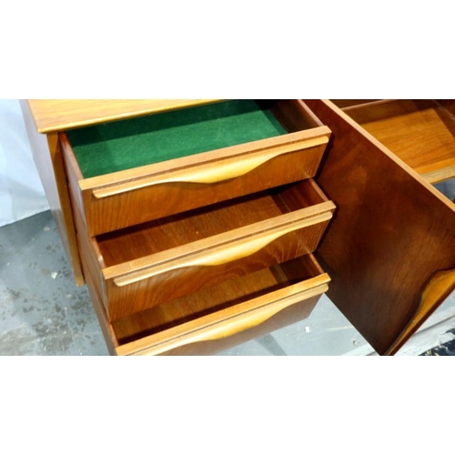 2161 - Long teak sideboard with central cupboard door, drop down asymmetric cupboard and three drawers, 183... 