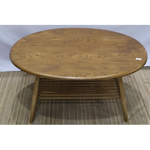 2166 - Ercol elm oval coffee table with stick under tier, 100 x 85 x 45 cm H. Not available for in-house P&... 