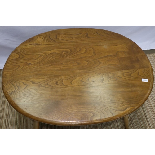 2166 - Ercol elm oval coffee table with stick under tier, 100 x 85 x 45 cm H. Not available for in-house P&... 