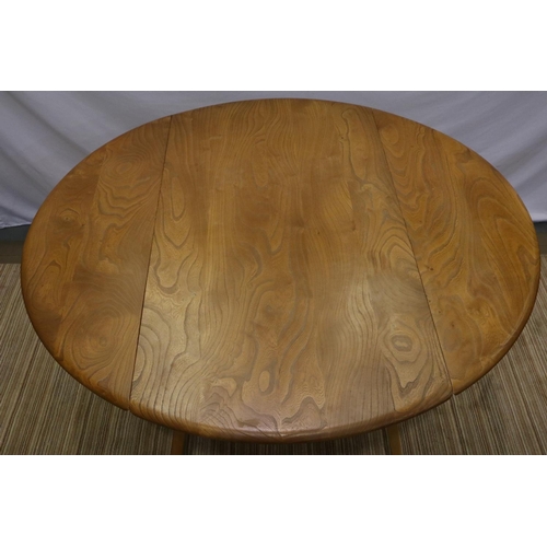 2171 - Ercol elm drop leaf circular table on supports, D: 120 cm. Not available for in-house P&P