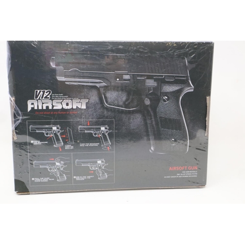 2122 - New old stock airsoft pistol, model V12 in brown, boxed and factory sealed. P&P Group 2 (£18+VAT for... 