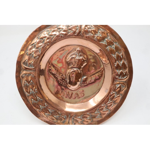 2228 - Two WWI copper relief trays for Royal Navy Air Service, with a WWI cap badge and War Service buttonh... 