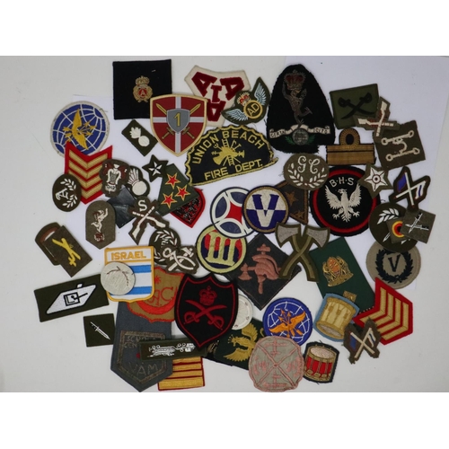 2260 - Thirty military trade/unit badges, with thirty overseas and foreign embroidered sleeve patches. P&P ... 