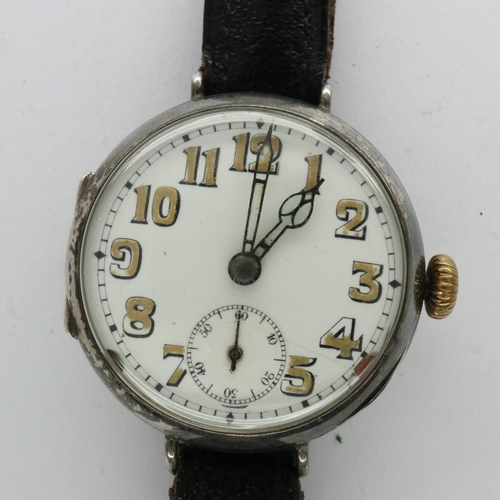 87 - Early continental silver wristwatch with luminous Arabic numerals on a black leather strap, runs the... 