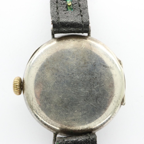 87 - Early continental silver wristwatch with luminous Arabic numerals on a black leather strap, runs the... 