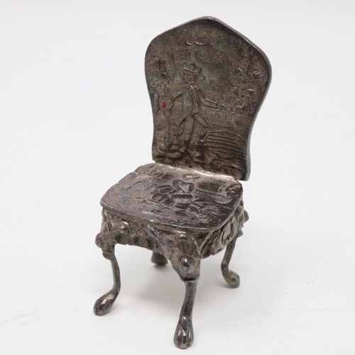 149 - Scottish hallmarked silver chair embossed with a garden scene, 23g, H: 50 mm, where the back of the ... 