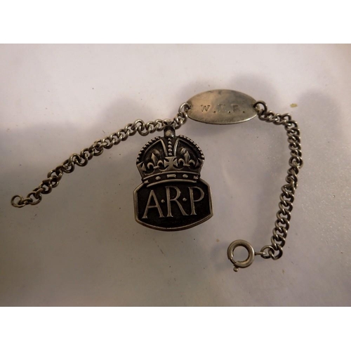 1080 - Hallmarked silver WWII ARP buttonhole and a silver identity bracelet. P&P Group 1 (£14+VAT for the f... 