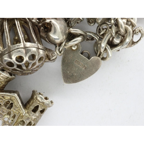 27 - Hallmarked silver charm bracelet with hallmarked silver padlock clasp and fourteen charms, L: 16 cm,... 