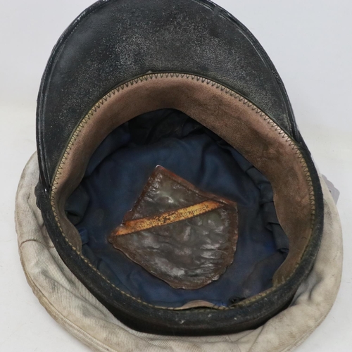 2107 - A German Kriegsmarine officers visor cap with flotilla badge, named to interior (indistinct). In dis... 