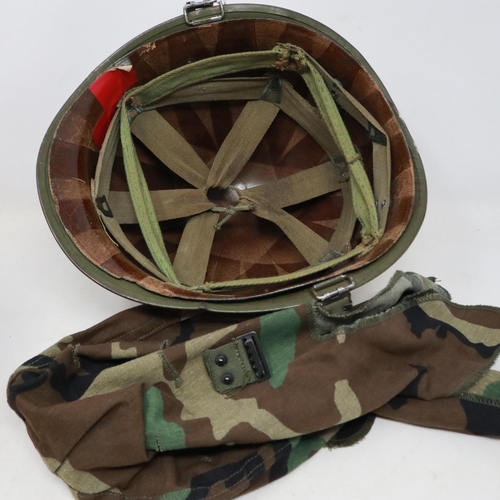 2113 - An American M-1 helmet and liner, with later memorial painting, with and camouflage cover. UK P&P Gr... 