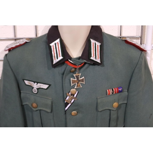 2168 - A German WWII reenactors officers tunic, displaying ribbon bar, Knights Cross, Iron Cross spange, wi... 