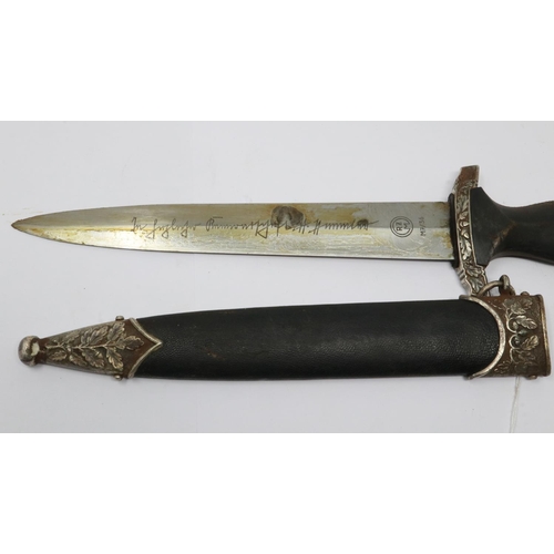 2186 - An aged replica SS presentation dagger with leather bound and metal mounted scabbard, etched blade a... 